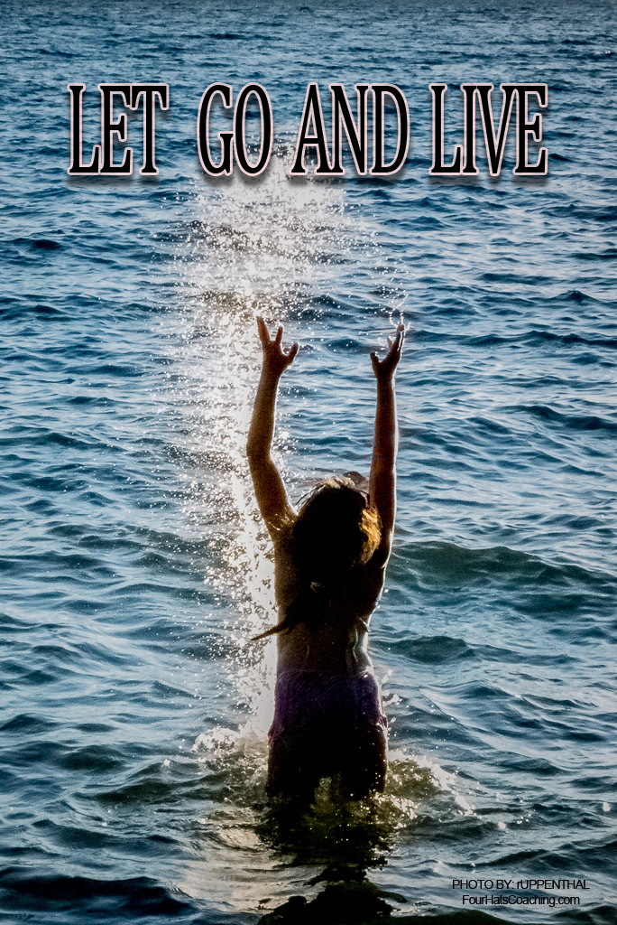 Child jumping out of the water, hands out stretched above her with the caption, Let go and live