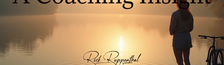 A person standing at the edge of a calm lake at dawn, soft golden light rising over still water. Gentle ripples form near their feet, symbolising clarity and potential. In the background, a bicycle rests on a quiet path, representing natural ability and resilience.